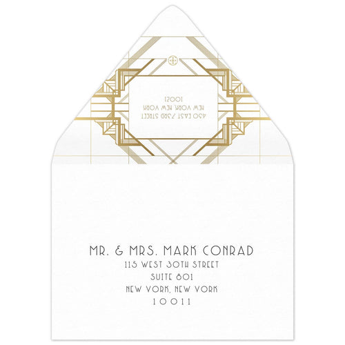 White envelope with gold geometric lines on the back flap. White box in between the lines of a deco font of the reply address. Black deco mailing address centered on the front of the envelope.