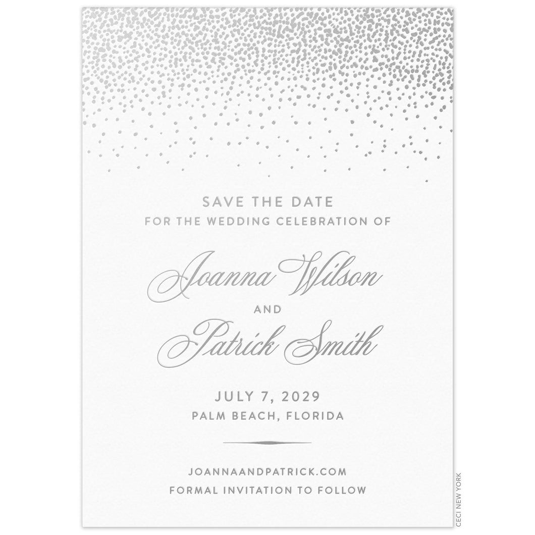 Silver small dots falling from the top of a white invitation. Block and script font centered underneath the dots on the middle of the card.