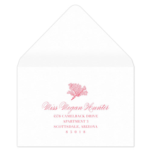 White envelope with coral motif with block and script return address centered underneath.