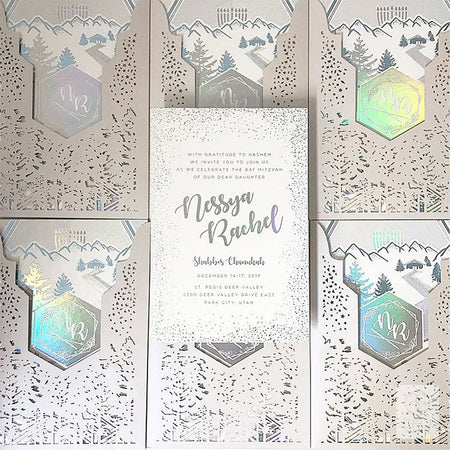 Winter lasercut mitzvah inviation with holographic foil details