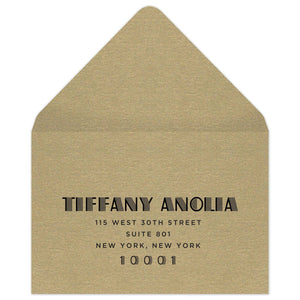 Gold reply envelope with black deco font centered on the front of the envelope.