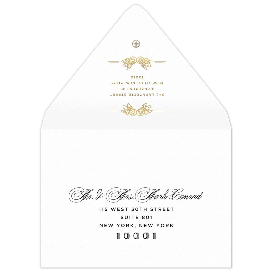 White envelope, small deco flourishes on the top and bottom of the return address. Blakc script, block and deco mailing address on the front of the flap.