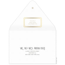 Load image into Gallery viewer, Gold decorative box holding the return address on the back of the envelope flap. Small circle logo on the tip of the flap. Black deco and block copy centered on the front of the envelope.