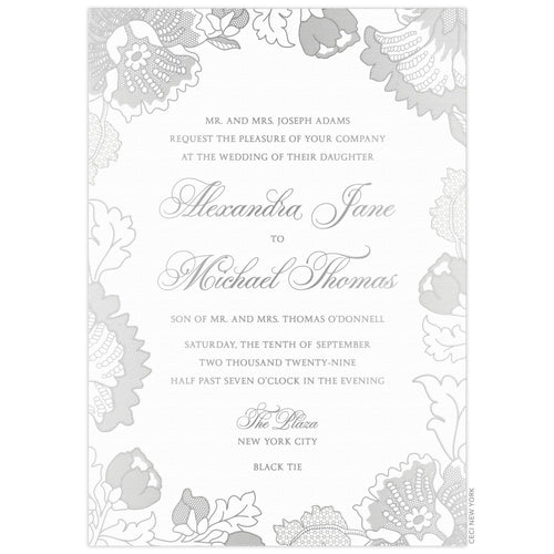 White invitation with lace florals in silver foil on all edges. Block and script font centered on the page.