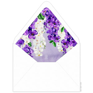 White envelope with purple watercolor liner, purple and white watercolor orchids dripping from the top of the flap.
