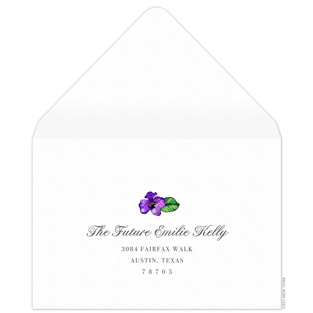 White reply envelope, script and block return address centered on the page, small watercolor orchid flourish