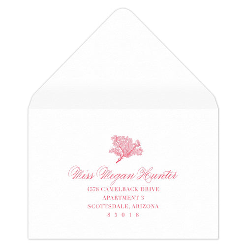 White envelope with coral motif with block and script return address centered underneath.