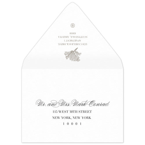 White envelope with a coral motif and block return address on the flap. Scrip and block address on the front.