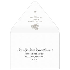 White envelope with a coral motif and block return address on the flap. Scrip and block address on the front.