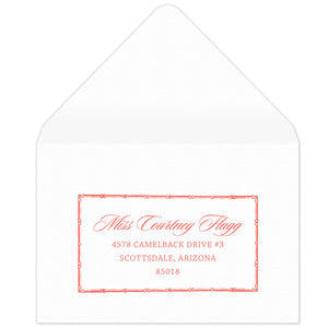 Bamboo rectangle holding block and script coral return address on a white envelope.