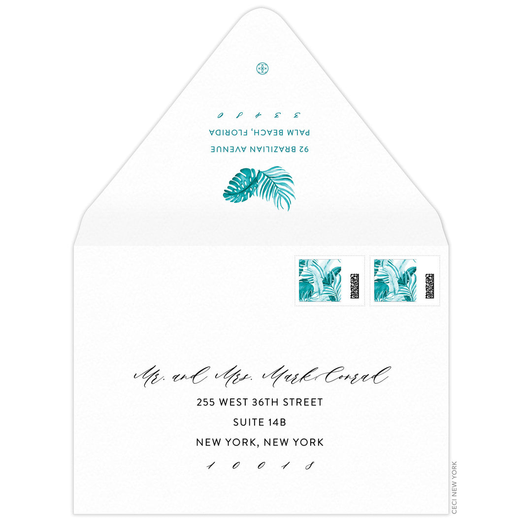 Turquoise watercolor palm leaves on top of return address on back flap of a white envelope. Script and block address on the front of the envelope.