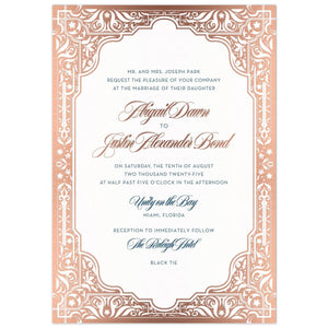 Middle Eastern border in rose gold on all edges of the invitation card. Navy and Rose gold block and script font centered in the frame.l