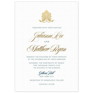 the front of a white paper invitation with gold lotus monogram on top with gold script and blue block font