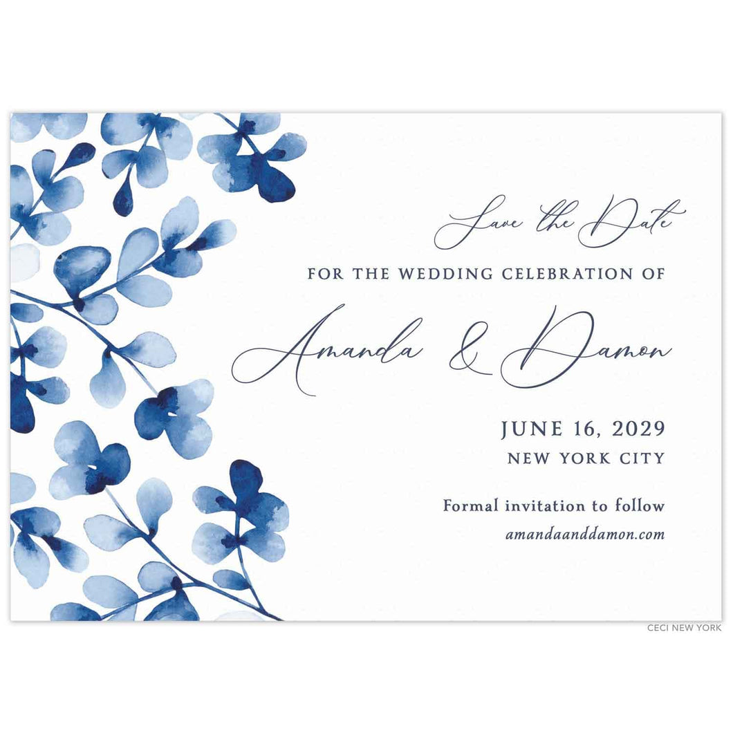 Blue watercolor leaves on the left side. Block and script font in navy centered on a white invitation.